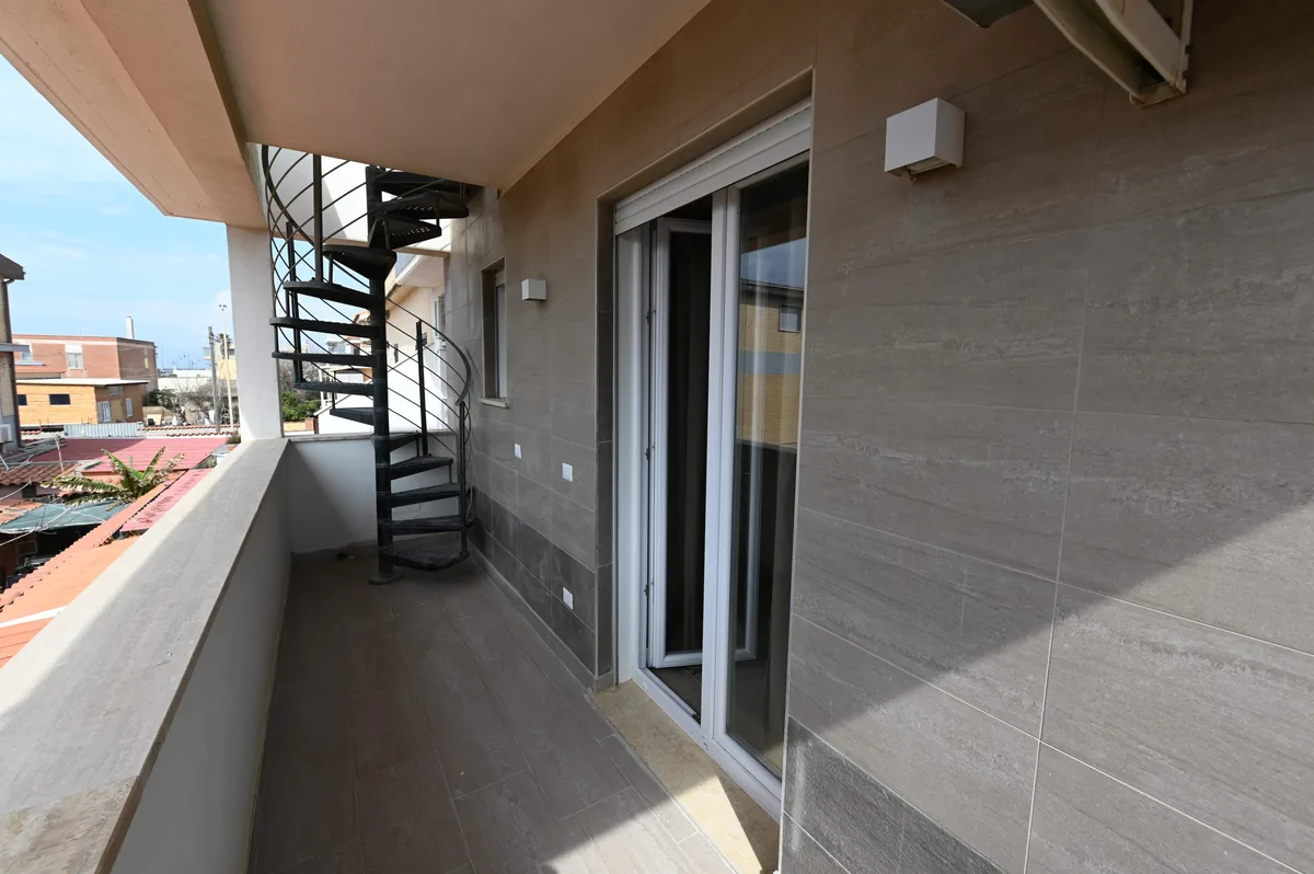 Balcony and spiral staircase to a sea-facing rooftop terrace